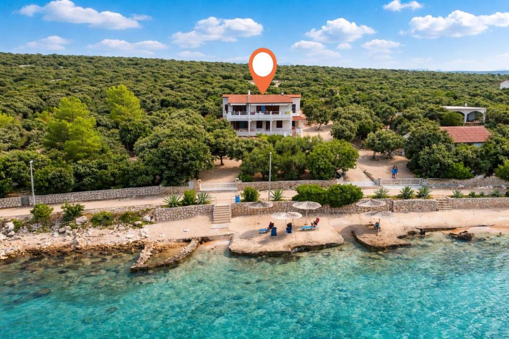 an aerial view of a resort with a sign in the water at Apartment Uga in Mandre