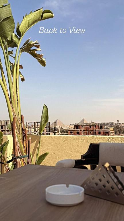 a table on the beach with a view of the sand at K Boutique Hotel - Pyramids & GEM - Roof in Cairo