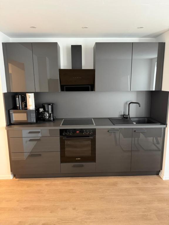 a kitchen with a sink and a stove at Schalke Unterkunft in Gelsenkirchen