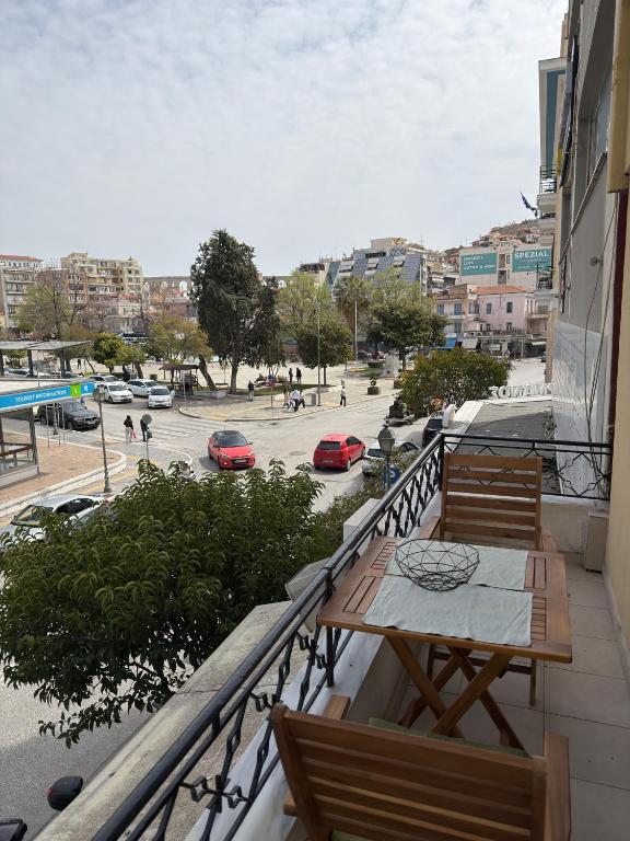 a balcony with a table and chairs on a building at Down Town Apartments in Kavála