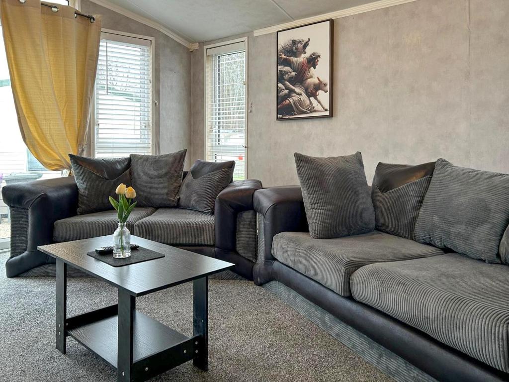 a living room with two couches and a coffee table at The Meadow - Uk51411 in Brechin