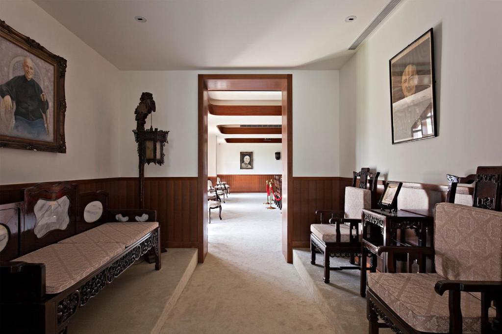 a room with beds and chairs and a hallway at Gloria Manor in Kenting