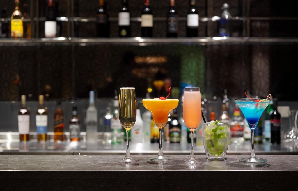 a group of four cocktails sitting on a bar at Gloria Manor in Kenting