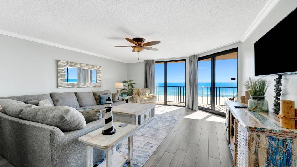 a living room with a couch and a ceiling fan at Phoenix X 514 condo in Orange Beach