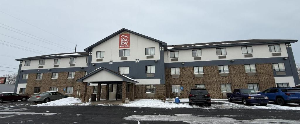 a large building with cars parked in a parking lot at Red Roof Inn & Suites Hammond, IN in Hammond