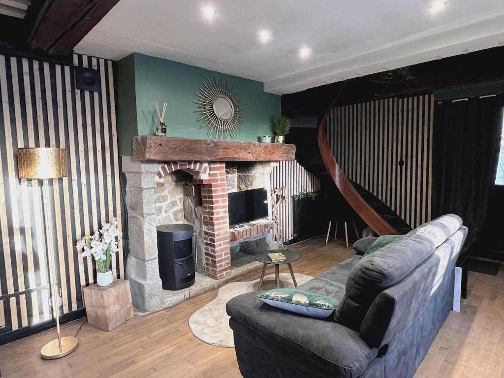 a living room with a couch and a fireplace at Romantic love room house in Aix
