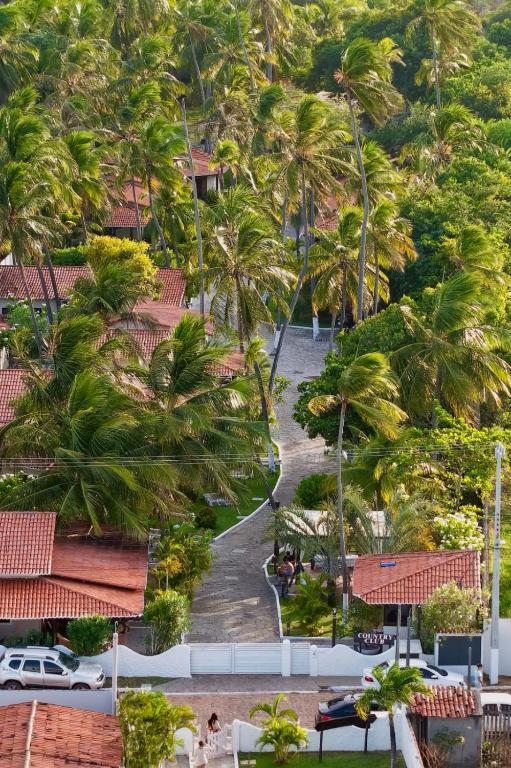 an aerial view of a resort with palm trees at Country Club Pititinga in Pititinga