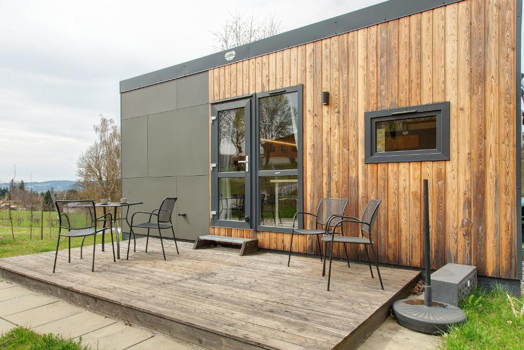 a house with chairs and a table on a deck at Haus Heike in Untergriesbach