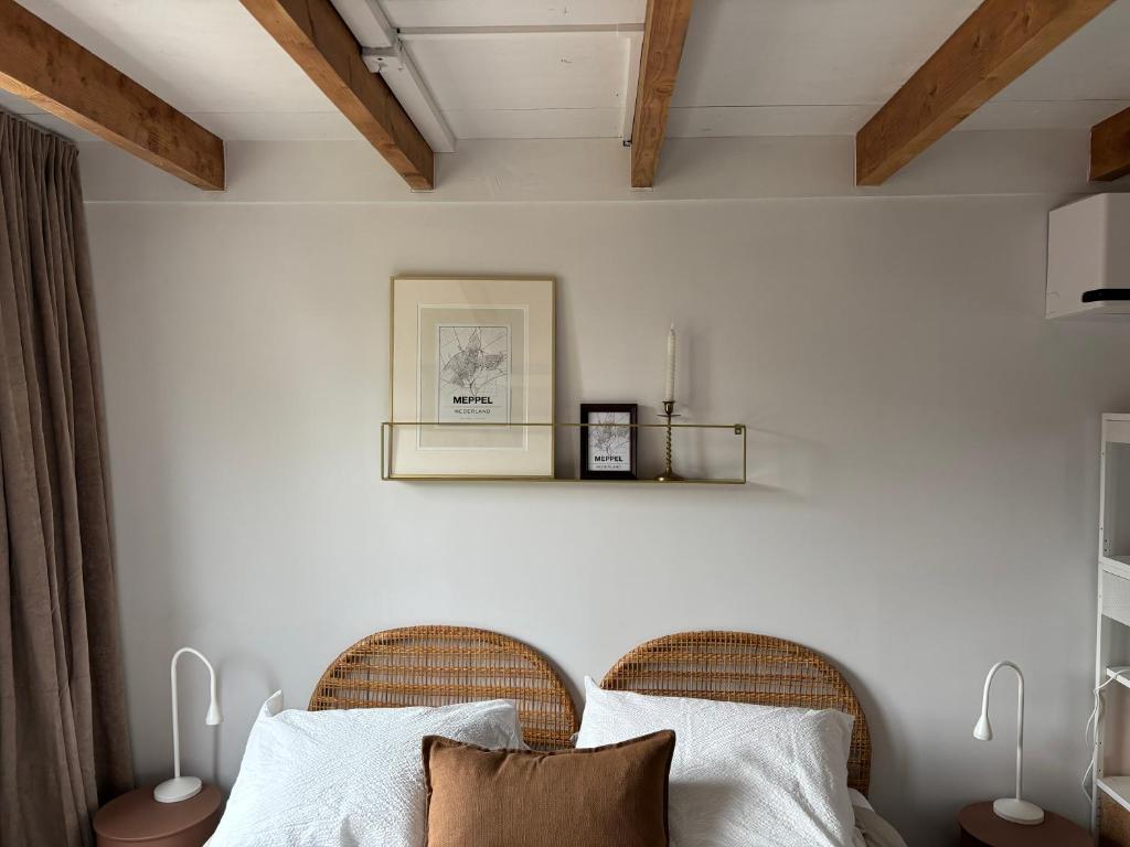 a bedroom with two wicker chairs and a bed at TuksandDutsMeppel in Meppel