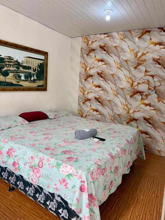 a bedroom with a bed and a stone wall at Apartamento no Centro in Manaus