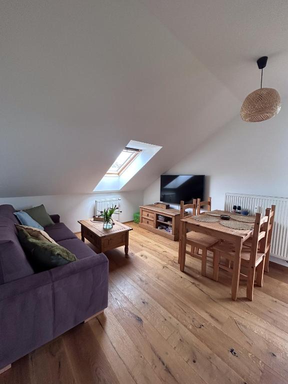 a living room with a couch and a table at Apartmán Kašperk in Vacov