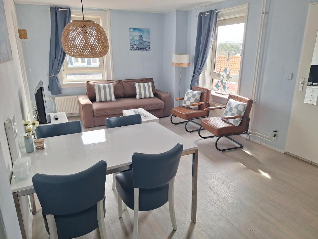 a living room with a table and chairs and a couch at Appartementen Zandvoort in Zandvoort
