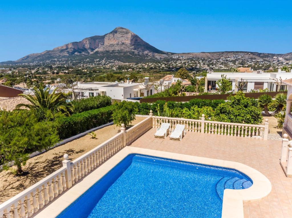 a villa with a swimming pool and a mountain at Villa Del Sol - Solo Familias 1819 in Jávea