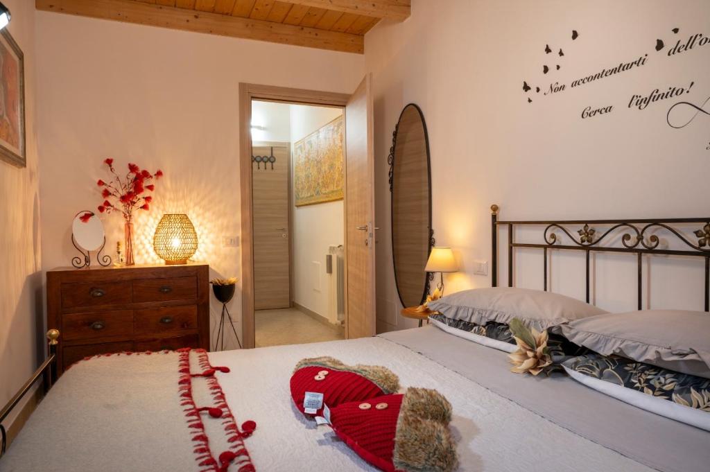 a bedroom with a bed and a dresser at Piccola Dimora Arco Ricci in LʼAquila