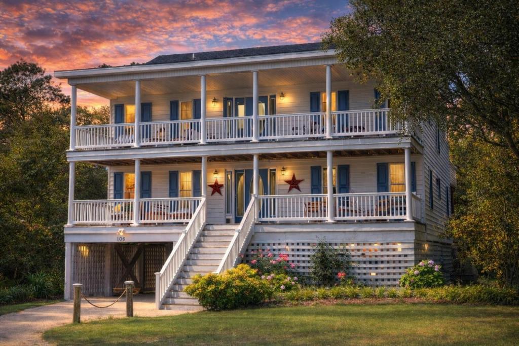 a large white house with a porch and stairs at Gone With The Wind - Duck, Gull's Flight, 325 Yds to Beach, Pool, Hot Tub, Pets OK, Quiet St, Flex Stays in Duck