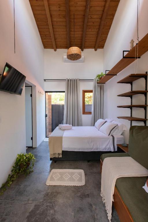a bedroom with two beds and a staircase at Casa Teiú in São Sebastião