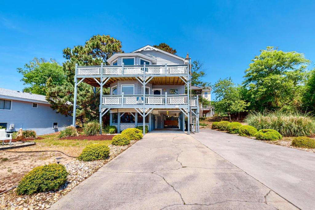 a house with a balcony and a driveway at Pelican Perch in Duck
