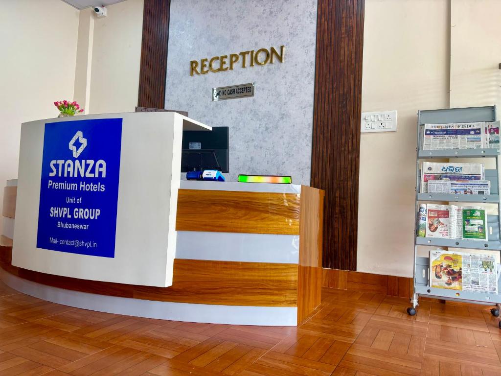 a reception desk in a store with a registration sign at Stanza Premium Hotels in Bhubaneshwar