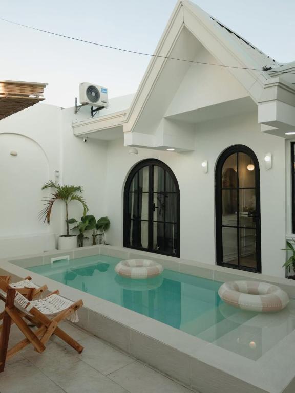 a swimming pool in a building with a house at White Villa in General Santos