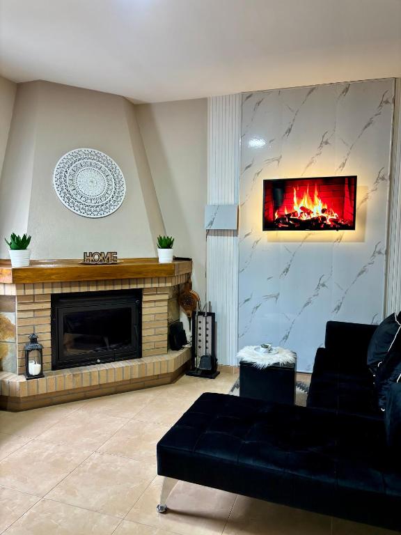 a living room with a couch and a fireplace at A Casiña do Patio in Quiroga