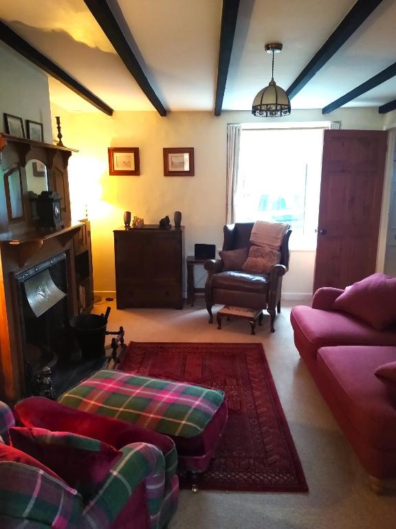 a living room with a couch and a chair at 7 Front Street in Saint Johns Chapel