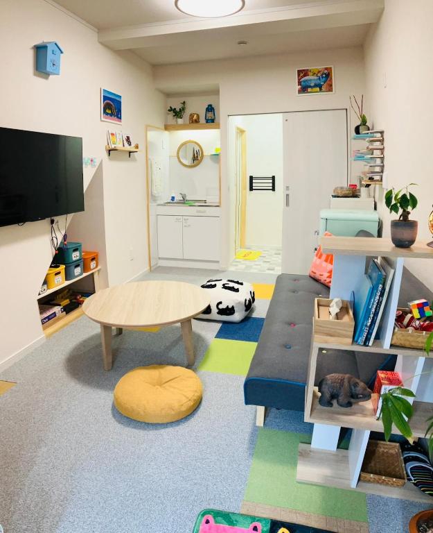 a living room with a couch and a table at 旅の宿 もはち Private Guesthouse MOHACHI in Tsuruoka
