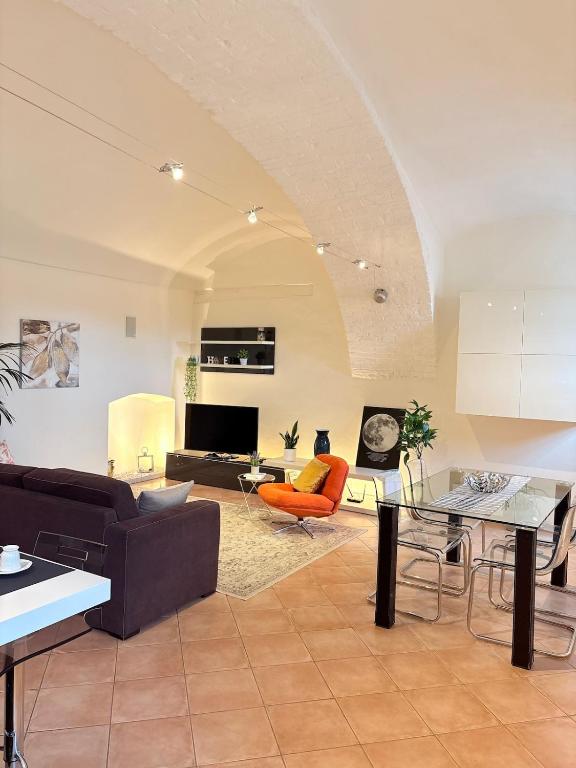 a living room with a couch and a table at Dimora Faglietto in Rivarolo Canavese
