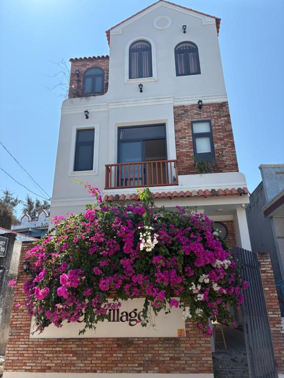 a building with flowers in a window box at Zen Village Lagi in Lagi