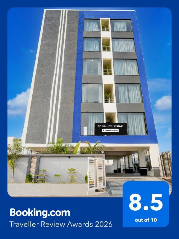 a tall building with a sign in front of it at Townhouse Nagole Metro Station Formerly Saka Arcade in Upal