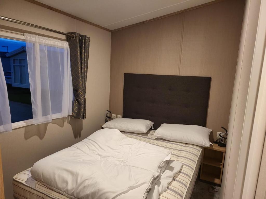 a small bedroom with a bed and a window at 181 northfield in Skipsea