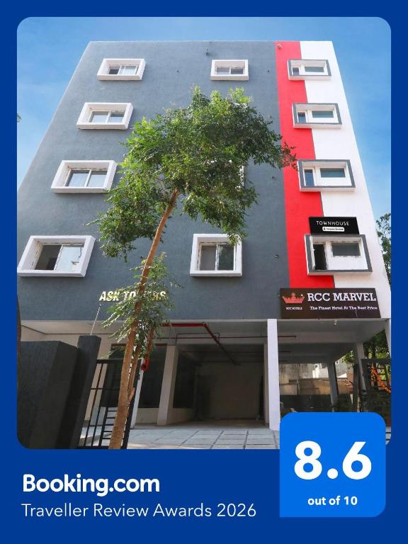 a building with a tree in front of it at Super Townhouse RCC Marvel in Hyderabad