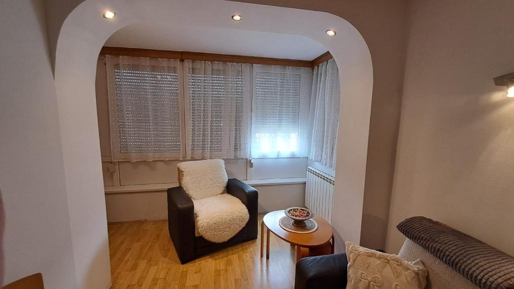 a living room with a chair and a window at Stan na dan bb in Bajina Bašta