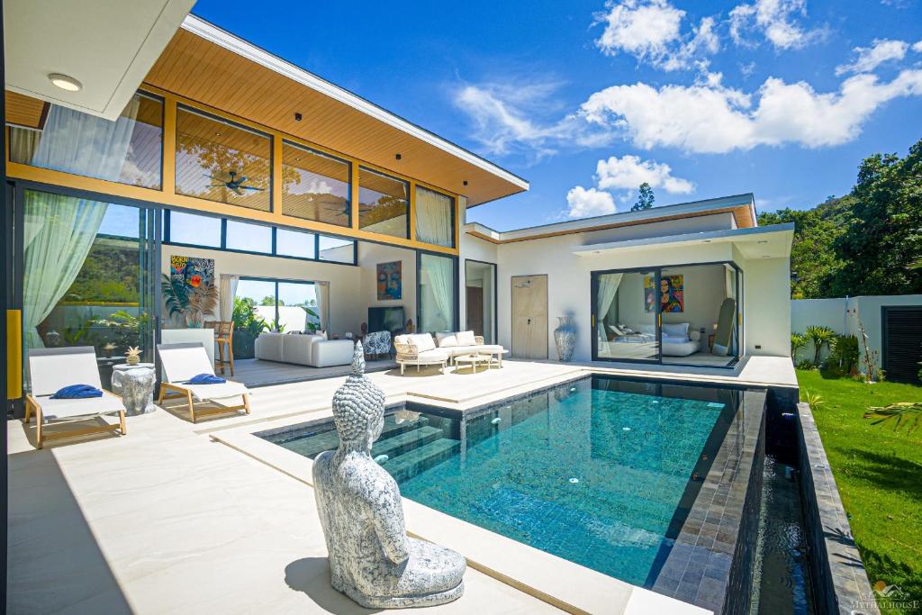 a house with a swimming pool in the backyard at Villa Babylon Chaweng in Koh Samui