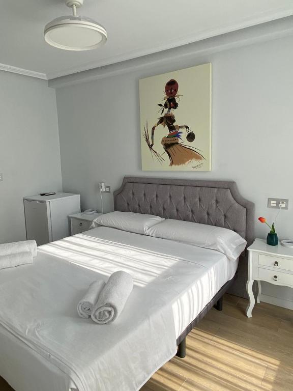 a bedroom with a bed with two towels on it at Mar Apartments Alicante, Playa de San Juan in Alicante
