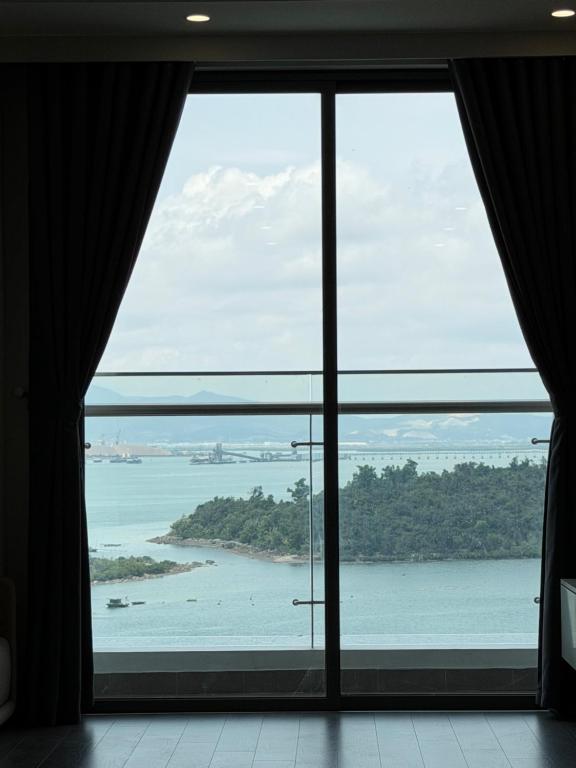 a room with a large window looking out at the ocean at The Ruby Hạ Long in Ha Long