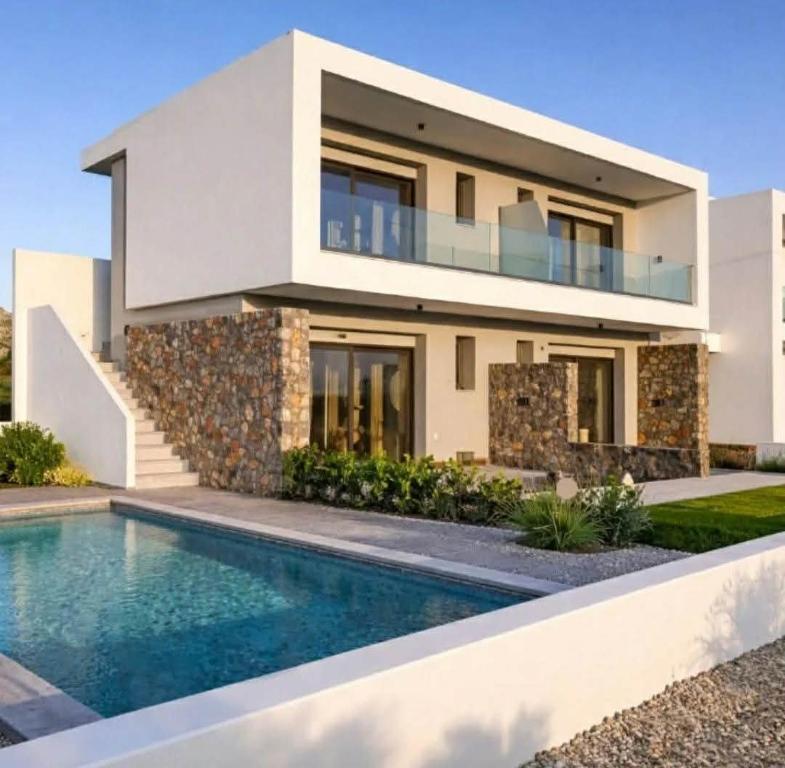 a house with a swimming pool in front of it at Haraki Sunstone in Haraki