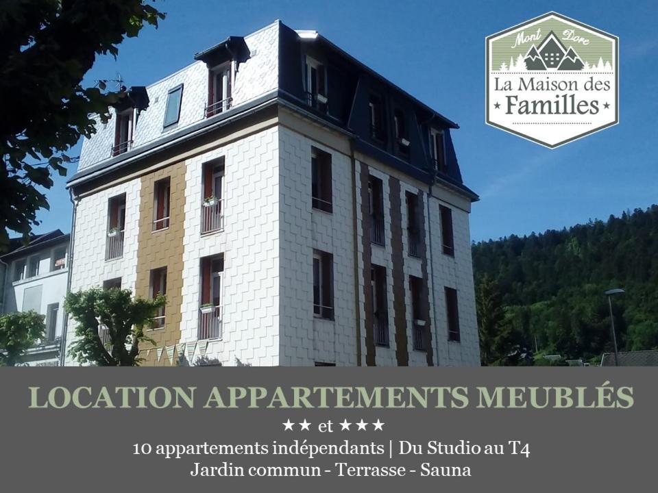 a building with a sign that reads location improvements molecules at La Maison des Familles 10 appartements in Le Mont-Dore