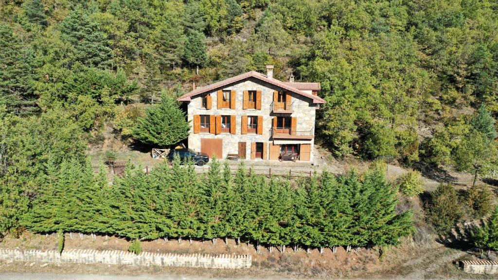 an aerial view of a house on a hill with trees at Casa Rural Uria in Gavín