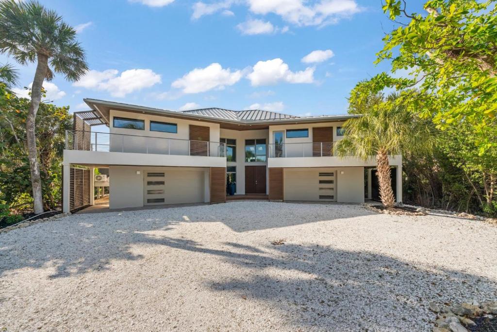 a house with a large driveway in front of it at Bentley Beach House in Sanibel
