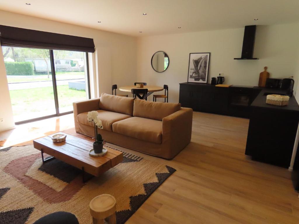 a living room with a couch and a table at Appartement 2 chambres Rochefort in Rochefort