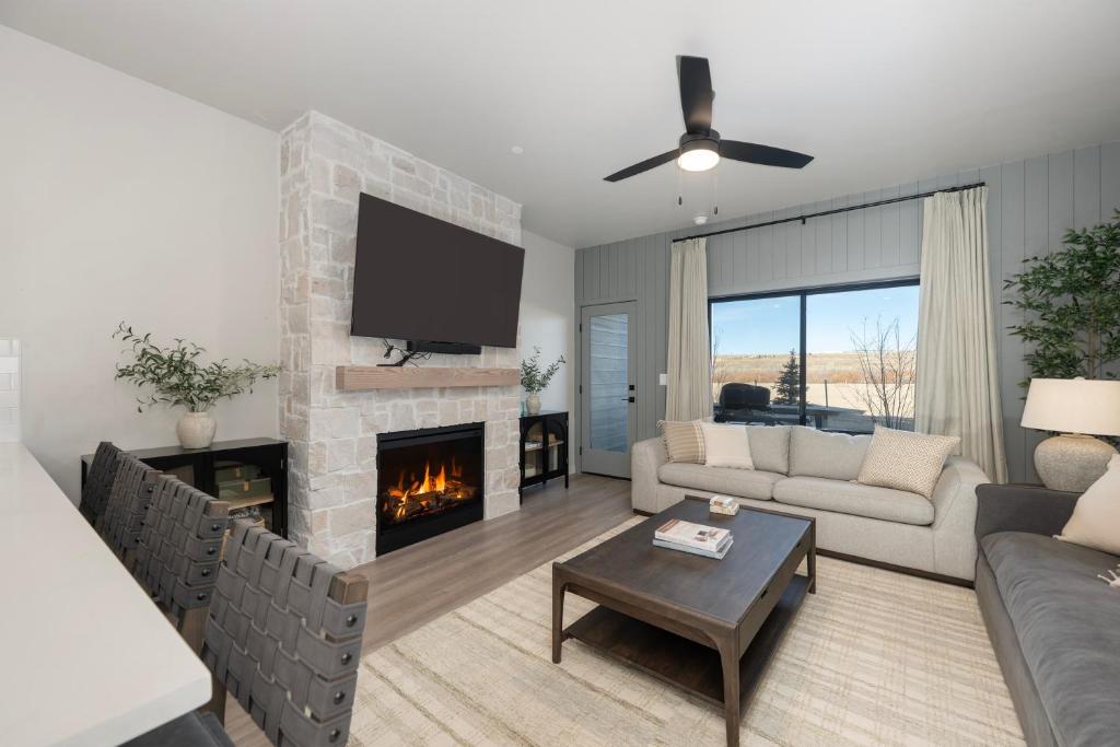 a living room with a couch and a fireplace at 103 Granby Meadow Dr in Granby