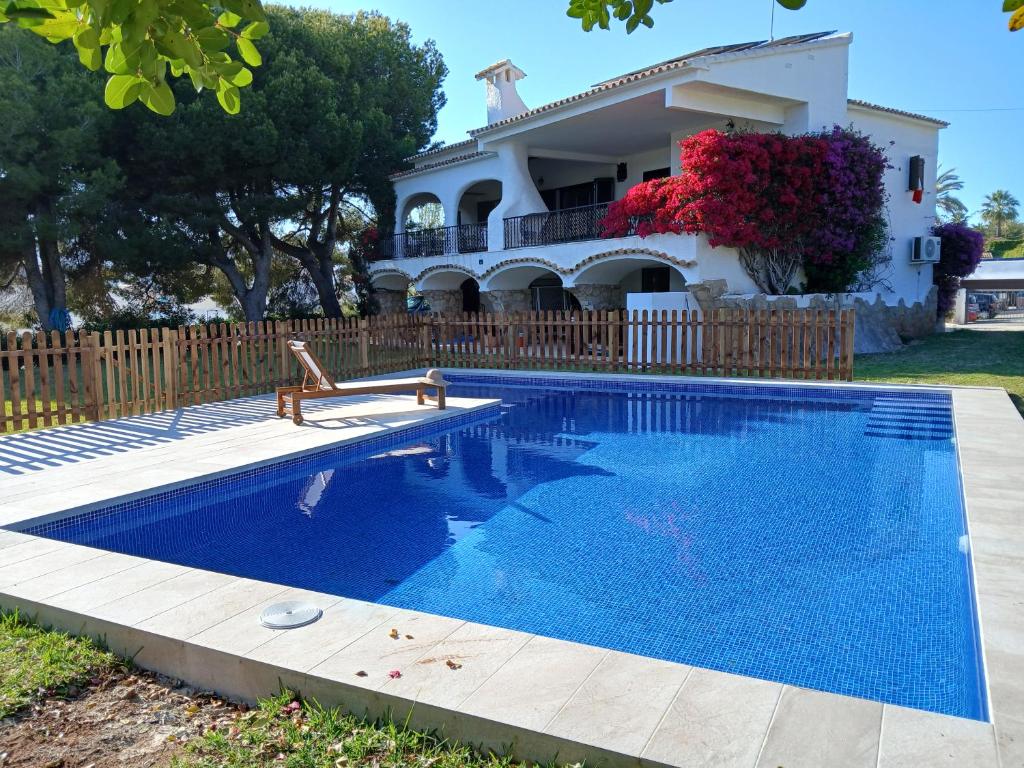 a swimming pool in front of a house at Chichen Itza in Moraira