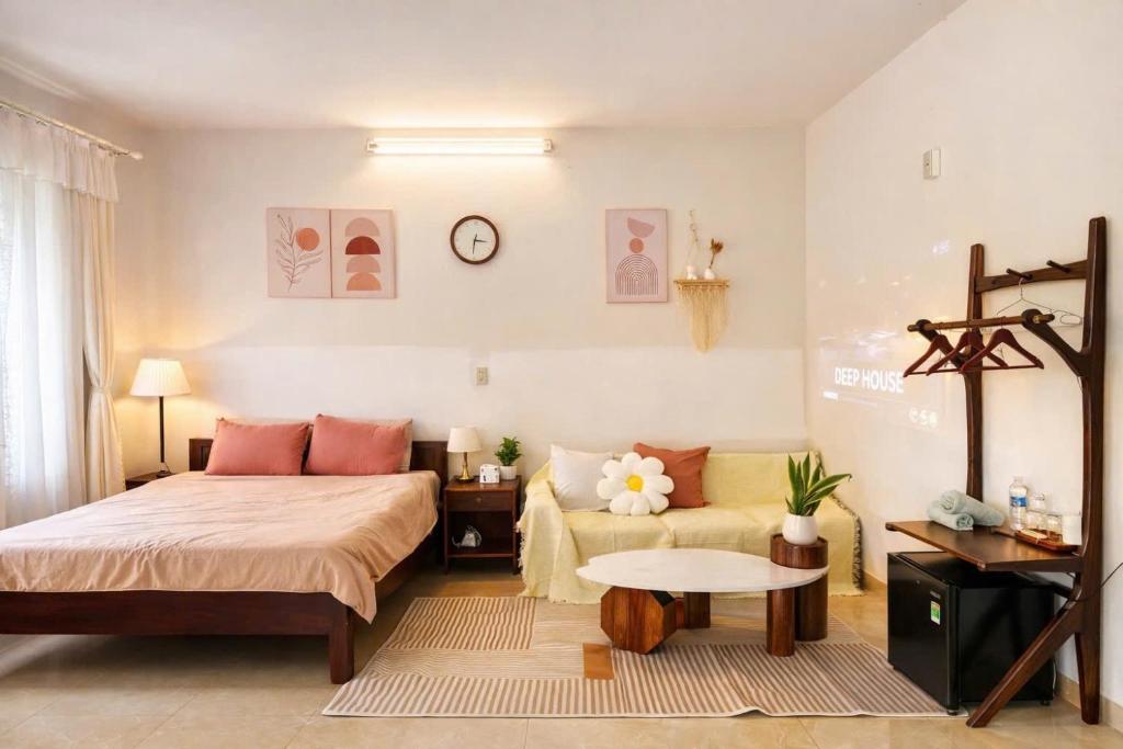 a bedroom with a bed and a couch at Green home, Huế in Thôn Trường Giang