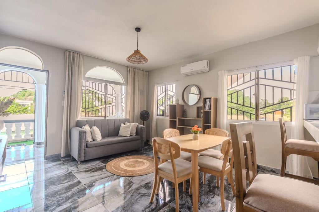 a living room with a table and a couch at Oz Residence Beach Two-Bedroom Apartment & Free Parking in Los Botados
