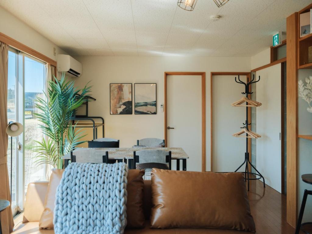 a living room with a couch and a table at Aso Grand View in Aso