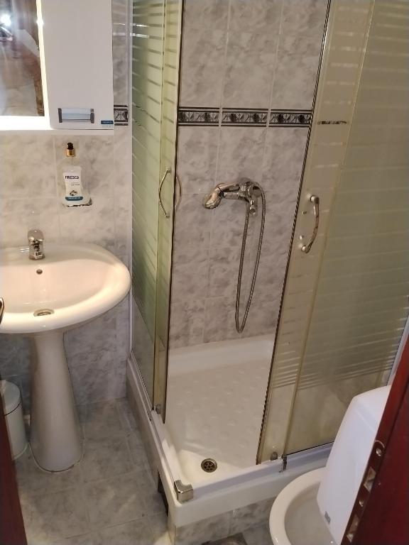a bathroom with a shower and a sink at Motel Buče in Berane