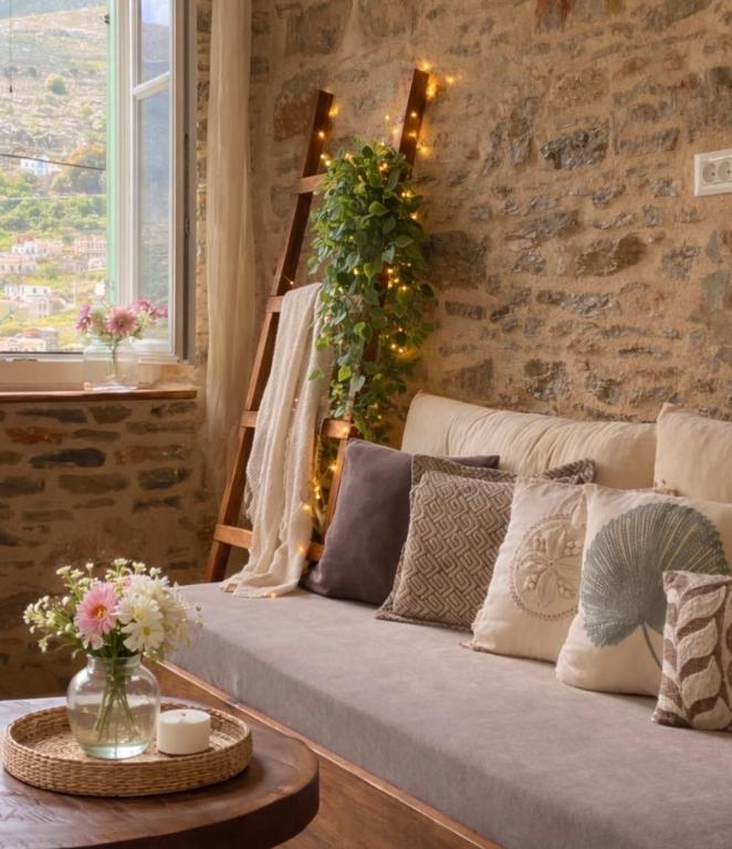 a living room with a couch with flowers on it at Katrani studios in Symi