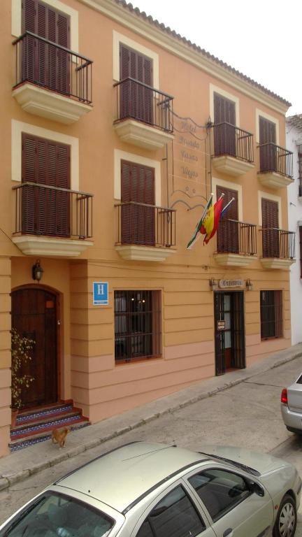 a building with a kite flying in front of it at Hotel Posada Casas Viejas in Benalup Casas Viejas