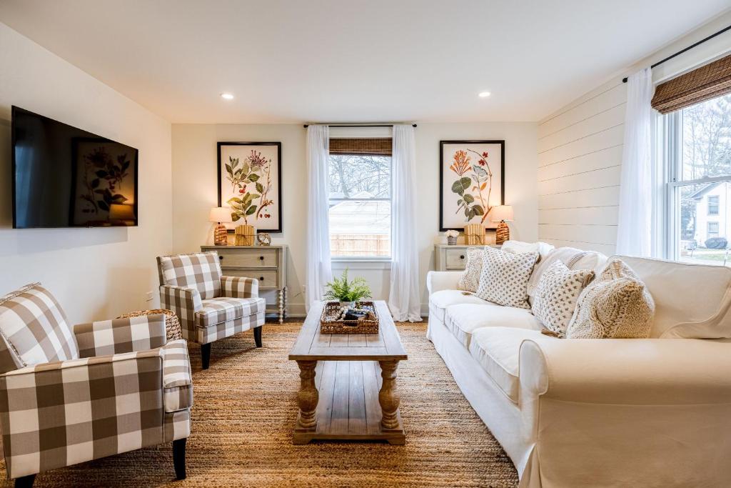a living room with white couches and a table at Kildahl House - Boutique Farmhouse Suite #4 in West Dundee