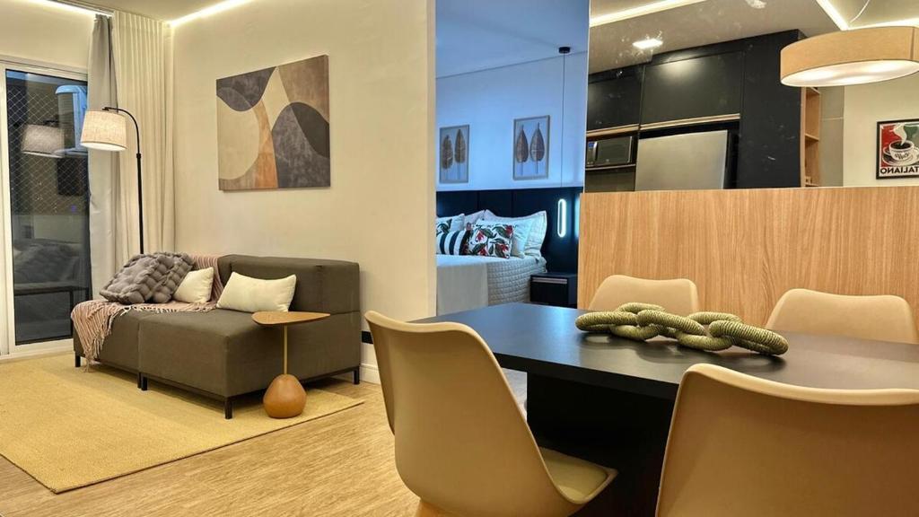 a living room with a table and a couch at Studio Red 14 - Sorocaba in Sorocaba